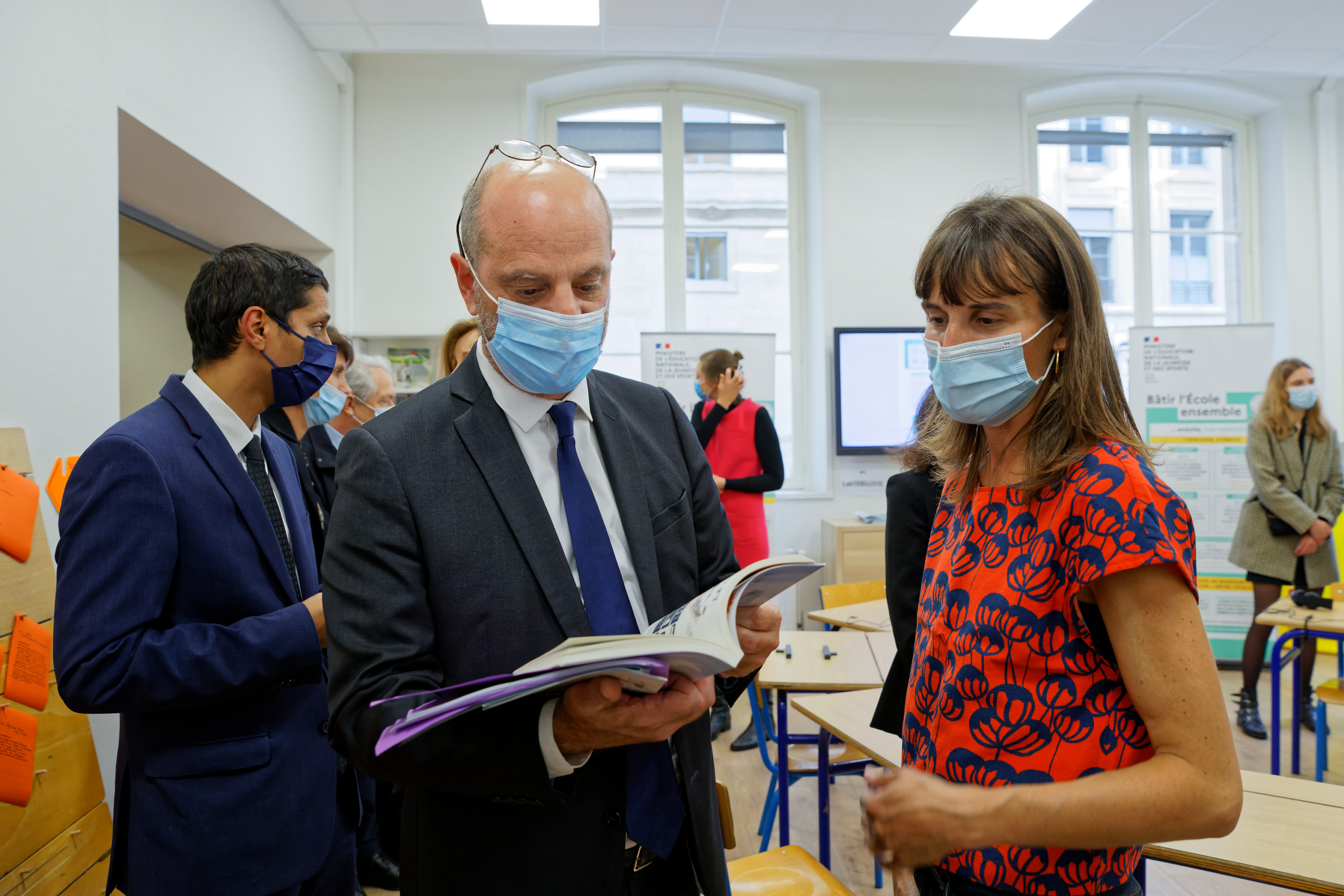 Jean-Michel Blanquer lit un guide